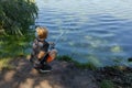 A teenager holds a fishing rod and watches a fish nibble. Sport fishing on the river in summer Royalty Free Stock Photo