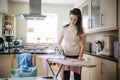 Teenager Ironing Laundry