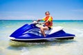 Teenager on jet ski. Teen age boy water skiing. Royalty Free Stock Photo