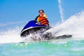 Teenager on jet ski. Teen age boy water skiing. Royalty Free Stock Photo