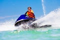 Teenager on jet ski. Teen age boy water skiing.