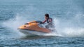 Teenager on Jet Ski-Water Sports in the summer having fun on the beach