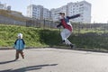 A teenager jumped high up dancing modern dances with his younger brother and teaches him Royalty Free Stock Photo