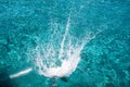 Teenager jumping freestyle to the blue sea from a boat