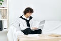 teenager laptop sitting on white sofa online training living room Royalty Free Stock Photo