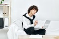 teenager laptop sitting on white sofa online training living room Royalty Free Stock Photo