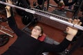Teenager lifting barbell with weight