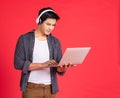 Teenager listen music via headphones on notebook Royalty Free Stock Photo