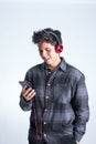teenager listening to music on his cell phone Royalty Free Stock Photo
