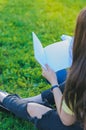 Teenager looking at notebook. Studying outdoors