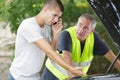 teenager making phonecall after car breaks down with dad Royalty Free Stock Photo