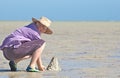 Teenager making sandcastles Royalty Free Stock Photo