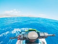 Teenager man enjoying summer in a jet ski in the middle of the sea having fun racing alone and isolated Royalty Free Stock Photo