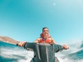 Teenager man enjoying summer in a jet ski in the middle of the sea having fun racing alone and isolated Royalty Free Stock Photo