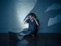 Teenager man suffering Internet cyber bullying sitting alone with computer feeling hopeless