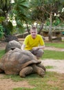 Teenager pats a turtle Royalty Free Stock Photo