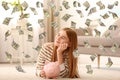 Teenager with piggy bank and flying money Royalty Free Stock Photo