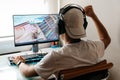 Teenager playing Fortnite video game on PC