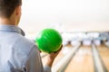 Teenager Playing With Green Bowling Ball In Club Royalty Free Stock Photo