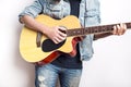 Portrait of a teenager playing guitar in studio wearing jeans jacket Royalty Free Stock Photo