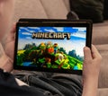 Teenager playing Minecraft on a tablet shallow depth of field