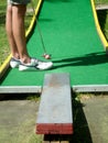 Teenager playing outdoor mini golf with copy space for your text