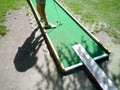Teenager playing outdoor mini golf with copy space for your text