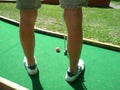 Teenager playing outdoor mini golf with copy space for your text