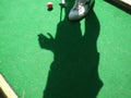 Teenager playing outdoor mini golf with copy space for your text