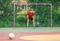 Teenager playing soccer. Playing football with a ball. Cute young boy player ready to play soccer on the indoor court Royalty Free Stock Photo