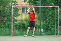 Teenager playing soccer. Playing football with a ball. Cute young boy player ready to play soccer on the indoor court Royalty Free Stock Photo