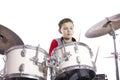 Teenager plays drums in studio with white background Royalty Free Stock Photo