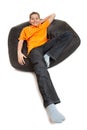 Teenager on pouffe Royalty Free Stock Photo