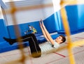 Teenager practicing alternate landings on trampoline