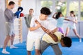Teenager practicing painful armlock in sparring during self defence training