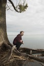 Teenager praying in solitude near lake