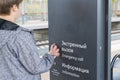 Teenager presses the emergency call button at station Royalty Free Stock Photo