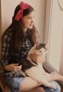 Teenager pretty girl cuddling with pet cat