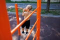 Street workout on a horizontal bar in the school park