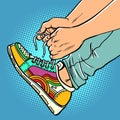 A teenager puts on sneakers, close-up, bright sports youth urban shoes