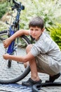 Teenager repairing his bike, changing broken tyre