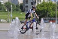 A teenager rides a bicycle on a fountain in Perm. Russia.