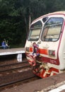 A teenager rides a train.