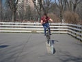 Teenager riding the bike on skateboarding area in park
