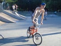 Teenager riding the bike on skateboarding area in park