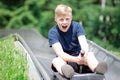 Teenager riding at bobsled roller coaster rail track