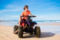 Teenager riding quad bike on beach Royalty Free Stock Photo