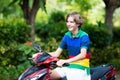 Teenager riding scooter. Boy on motorcycle Royalty Free Stock Photo