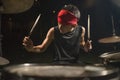 Teenager rock band drummer . cool and talented Asian American mixed ethnicity teenage boy playing drums in headband performing
