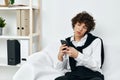 teenager in the room on the couch with the phone online learning communication Royalty Free Stock Photo